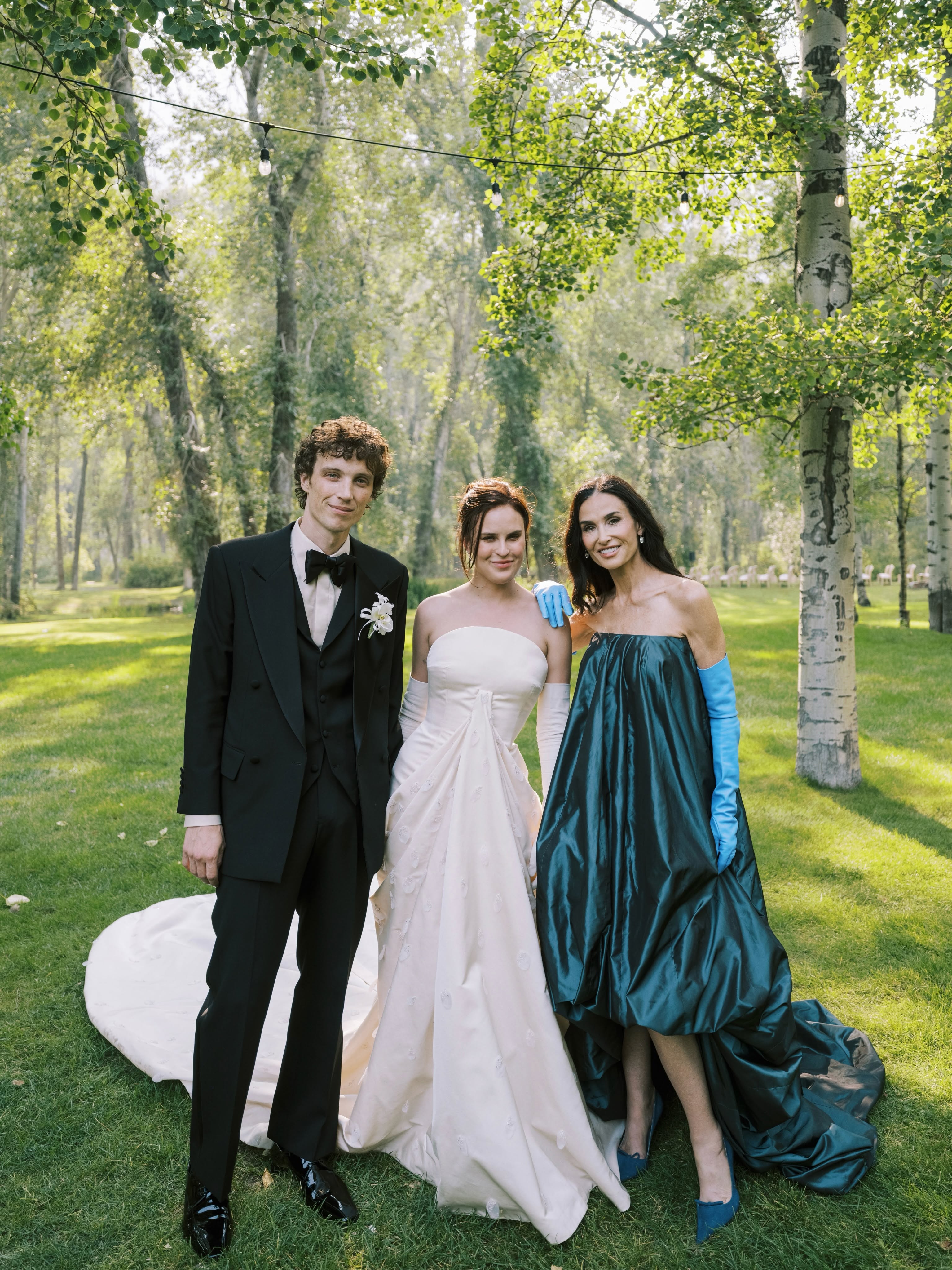 Colour wedding photo of Demi Moore with Tallulah Willis and Justin Acee outdoors at the ceremony